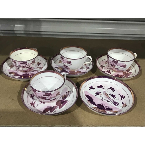 302 - A set of four 19th Century Sunderland pink lustre tea cups and five saucers, bird on a branch patter... 