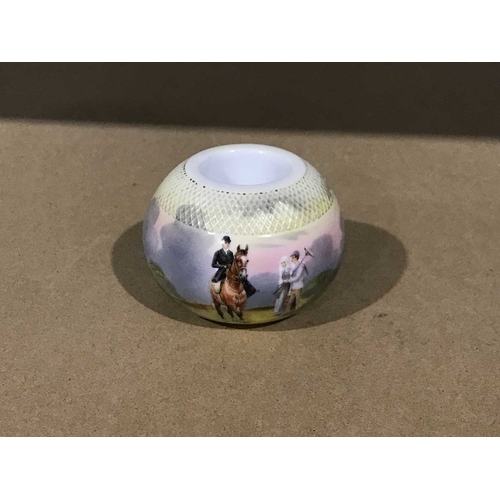 309 - A continental match striker, circa 1900, ball-shaped with a colour transfer print of a lady riding s... 