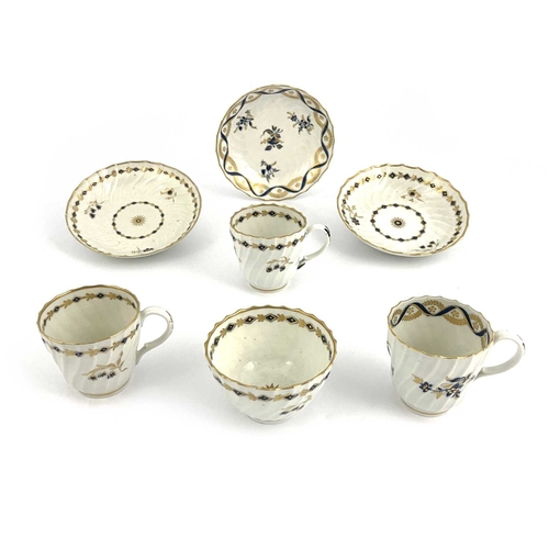 322 - A collection of Worcester Flight tea ware, circa 1780, wrythen fluted underglaze blue and gilt sprig... 