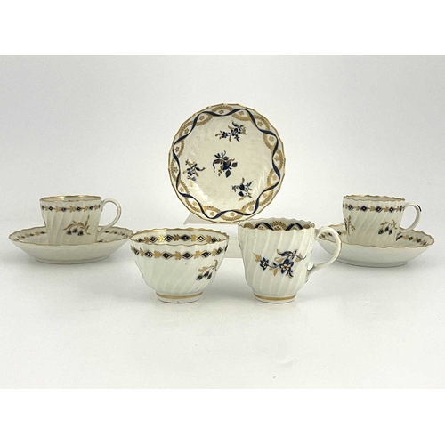 322 - A collection of Worcester Flight tea ware, circa 1780, wrythen fluted underglaze blue and gilt sprig... 