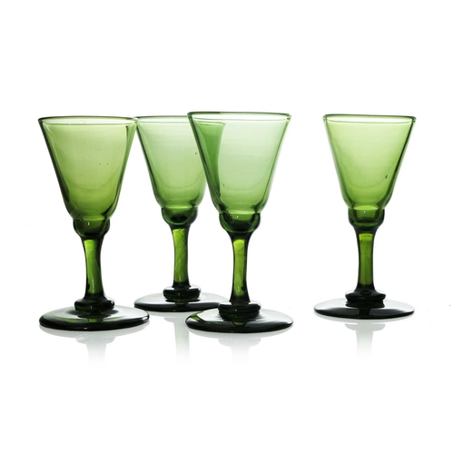 328 - A set of early 19th century green glass wine glasses, ogee conical form, circa 1830, on plain stems,... 