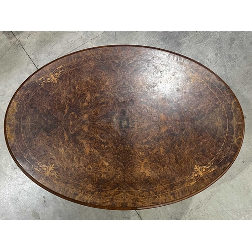 668 - A mid-Victorian oval marquetry inlaid burr walnut tilt-top centre table, circa 1860, on four cabriol... 