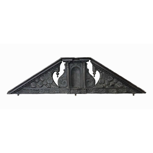 673 - An antique carved oak country house internal door pediment, scroll carved incorporating a central ni... 