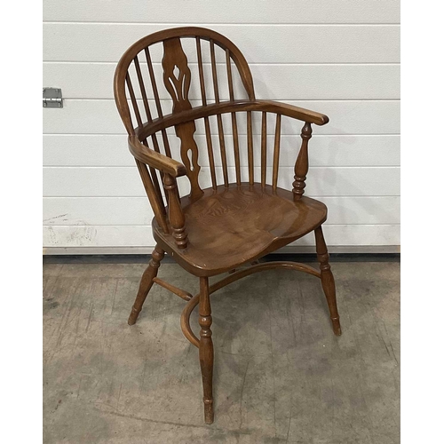 706 - A set of four reproduction Windsor armchairs, with bent wood top-rail and arm rests, linked by a pie... 