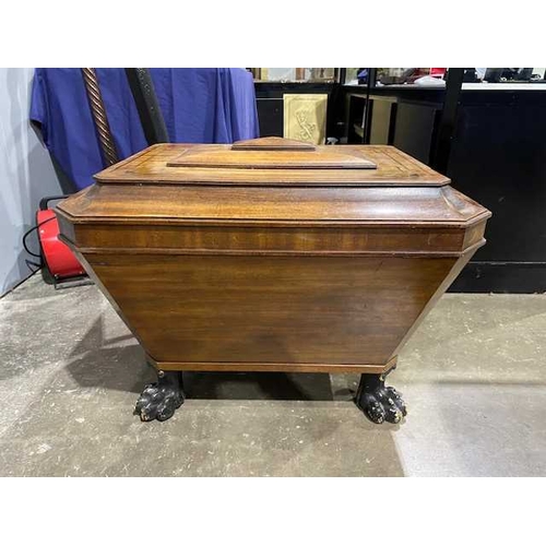 745 - A Regency mahogany cellarette, circa 1820, in the manner of Thomas Hope, of sarcophagus form with hi... 