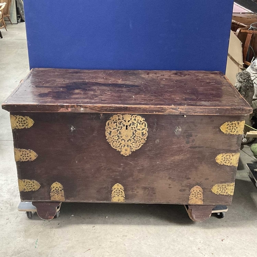 757 - A large hardwood antique style Indian dowry chest, reticulated brass bindings and escutcheon, on woo... 