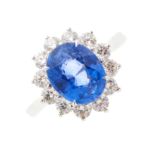 63 - An 18ct gold sapphire and diamond cluster ring, sapphire estimated weight 3.20ct, estimated total di... 
