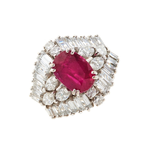 65 - An 18ct gold ruby and diamond cluster dress ring, with marquise-shape diamond sides and vari-cut dia... 