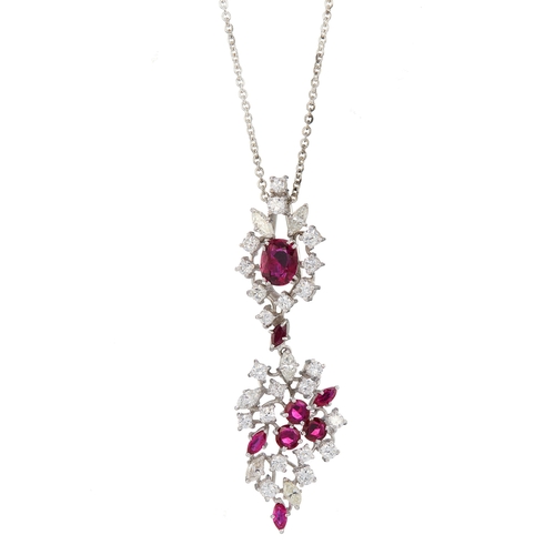 70 - An 18ct gold vari-shape ruby and vari-cut diamond drop pendant, suspended from a white metal chain, ... 