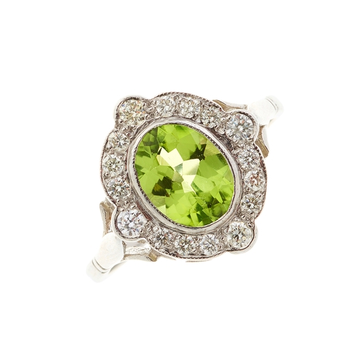 78 - A platinum peridot and diamond cluster dress ring, peridot estimated weight 1.35ct, estimated total ... 