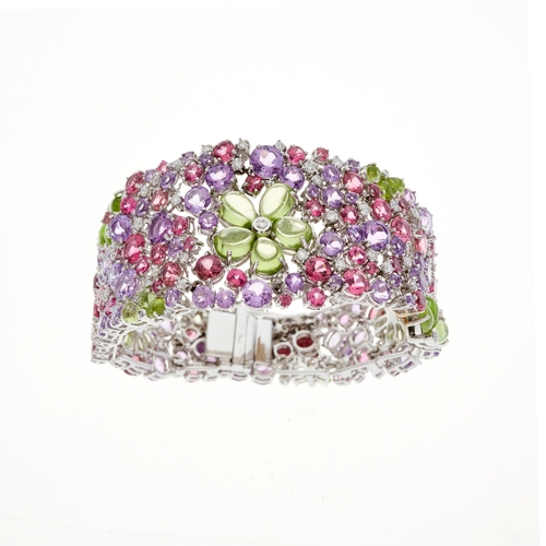 81 - An 18ct gold brilliant-cut diamond accent and multi-gem floral openwork bracelet, set throughout wit... 