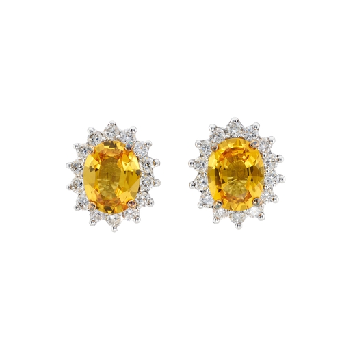 85 - A pair of 18ct gold yellow sapphire and brilliant-cut diamond cluster stud earrings, estimated total... 