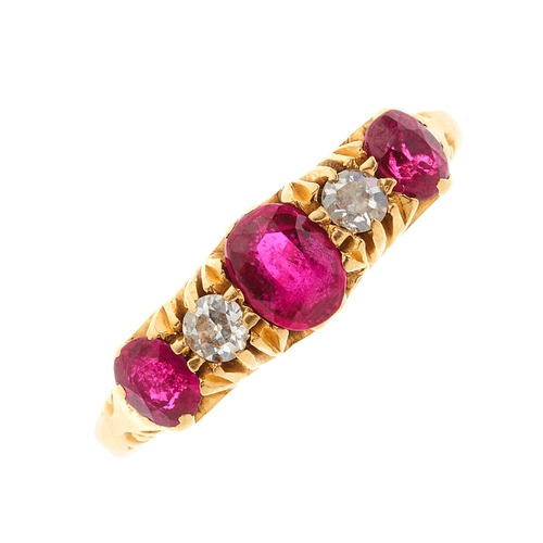 93 - An early 20th century 18ct gold graduated ruby three-stone dress ring, with old-cut diamond spacers,... 