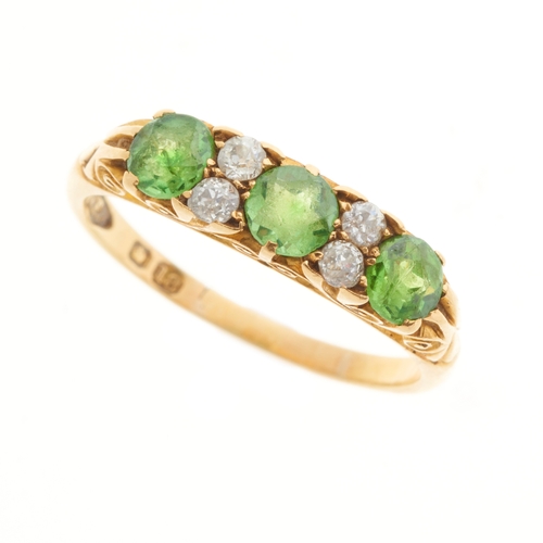 101 - An Edwardian 18ct gold demantoid garnet dress ring, with old-cut diamond double spacers, estimated t... 