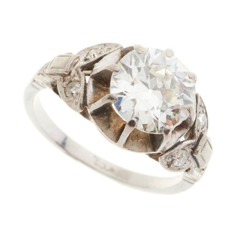 136 - A mid 20th century platinum circular-cut diamond single-stone ring, with vari-cut diamond accent sho... 