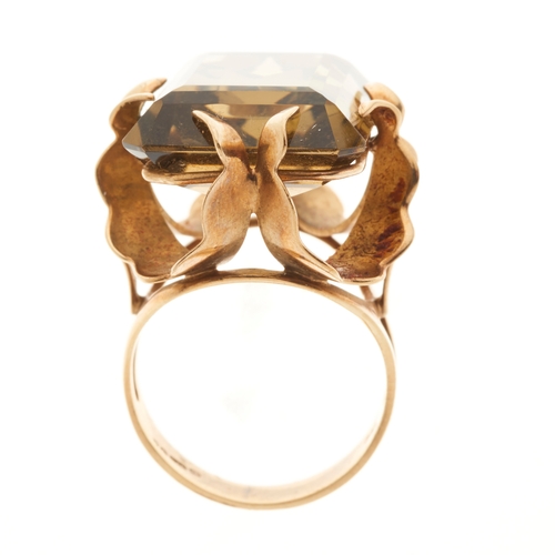 174 - A 1970s 9ct gold citrine single-stone cocktail ring, with fancy-shape claws, citrine estimated weigh... 