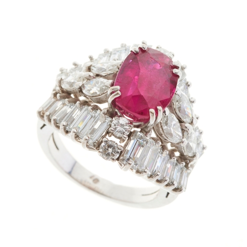 65 - An 18ct gold ruby and diamond cluster dress ring, with marquise-shape diamond sides and vari-cut dia... 