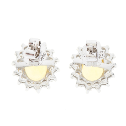 85 - A pair of 18ct gold yellow sapphire and brilliant-cut diamond cluster stud earrings, estimated total... 