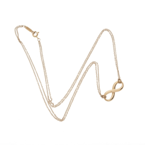 143 - Tiffany & Co., an 18ct gold Infinity pendant, suspended from a two-row trace-link chain, signed Tiff... 