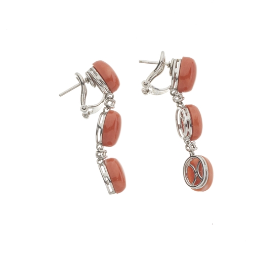 57 - A pair of 18ct gold oval coral cabochon three-stone articulated drop earrings, with brilliant-cut di... 