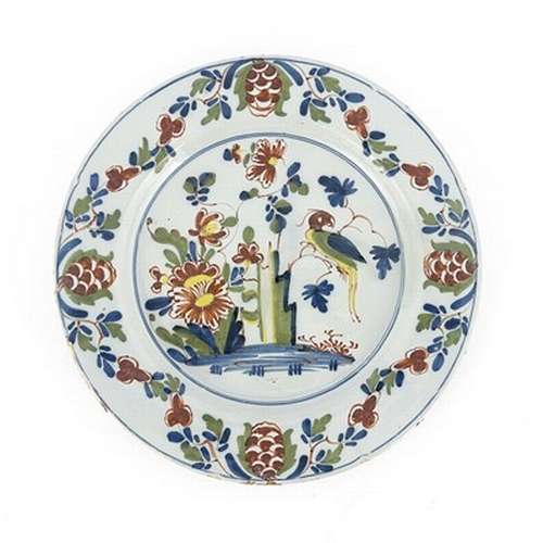 1000 - A Lambeth, London Delft polychrome charger, circa 1760, painted with a parrot on a peony rock, withi... 