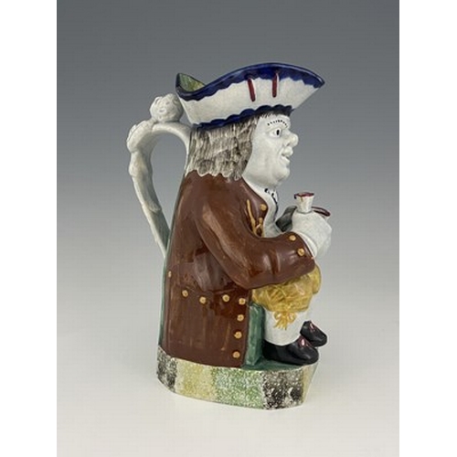 1001 - A Mexborough Toby jug, modelled holding a jug and a beaker, caryatid figural handle, sponge decorate... 