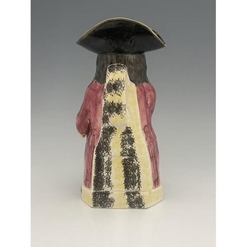 1002 - A Yorkshire Toby jug, circa 1800, modelled holding a frothing jug, pink coat and green breeches, 26.... 