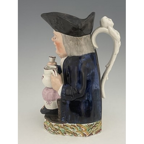 1003 - A Mexborough Toby jug, modelled holding a jug and a beaker, caryatid figural handle, black hat and s... 