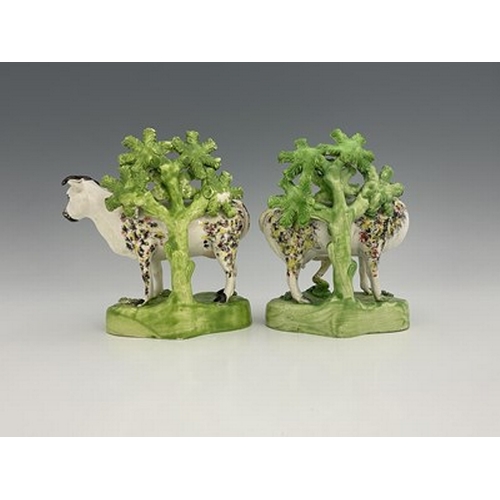 1008 - A pair of spongeware decorated figures of cows against bocage, Staffordshire, Tunstall Group, circa ... 