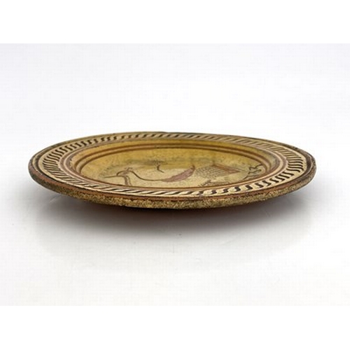 1009 - A slipware dish, sgraffito decorated with an image of a peacock and dated 1733, possibly Devon or So... 