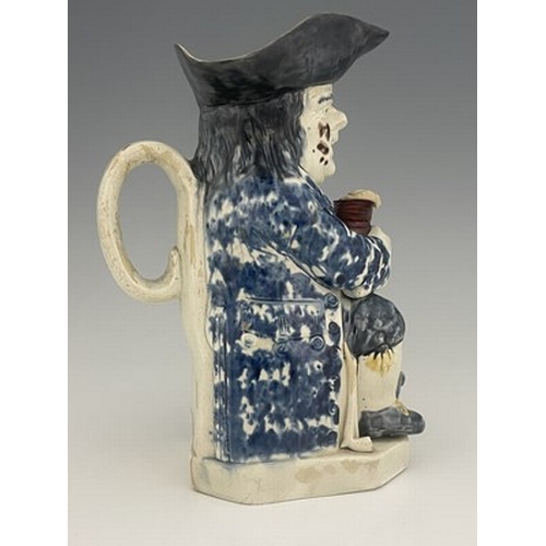 1013 - A Ralph Wood type Staffordshire Toby jug, circa 1770, modelled with frothing jug, barrel and resting... 