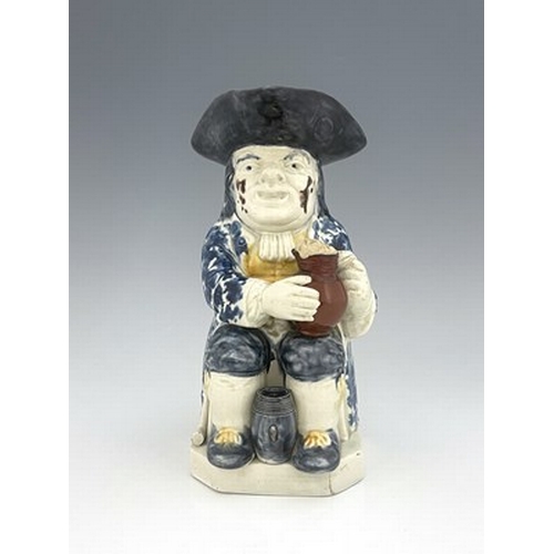 1013 - A Ralph Wood type Staffordshire Toby jug, circa 1770, modelled with frothing jug, barrel and resting... 