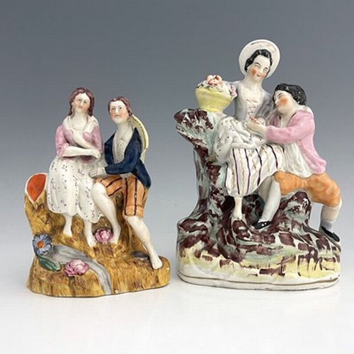 1019 - Two Staffordshire figure groups modelled as courting lovers on naturalistic, irregular bases, height... 