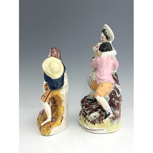 1019 - Two Staffordshire figure groups modelled as courting lovers on naturalistic, irregular bases, height... 