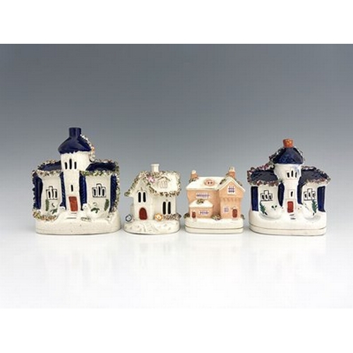 1020 - A Staffordshire figure group of cottages, 19th century, polychrome enamel painted with gilded highli... 