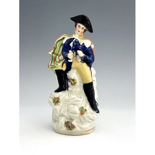 1022 - A Staffordshire portrait figure of Napoleon, circa 1840, modelled in military uniform and bicorn hat... 