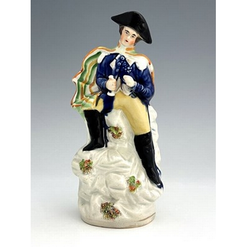 1022 - A Staffordshire portrait figure of Napoleon, circa 1840, modelled in military uniform and bicorn hat... 