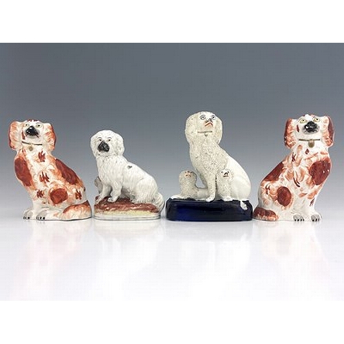 1028 - A collection of Staffordshire dogs, circa 1860, to include apair of seated Staffordshire spaniels, w... 