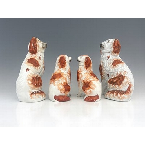 1029 - A Staffordshire figure group of spaniels, circa 1860, two matching pairs of seated Staffordshire spa... 