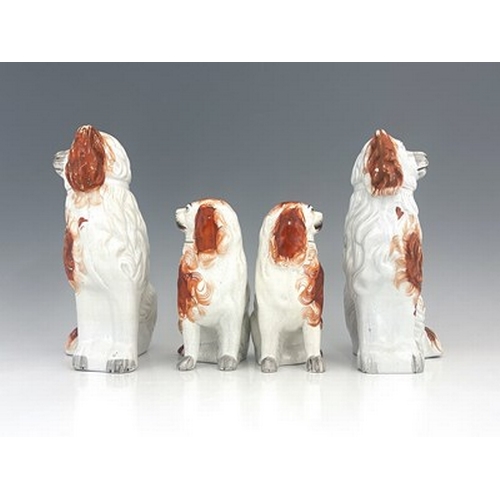 1029 - A Staffordshire figure group of spaniels, circa 1860, two matching pairs of seated Staffordshire spa... 