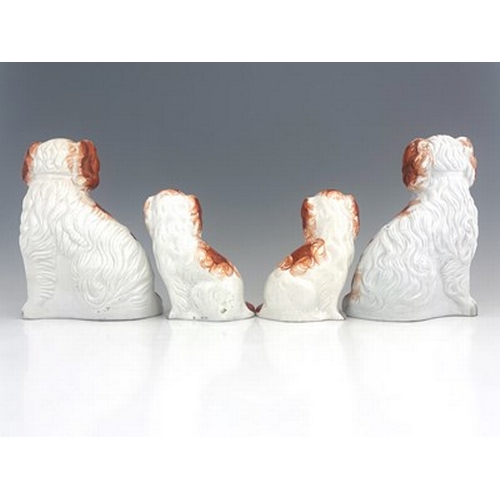 1029 - A Staffordshire figure group of spaniels, circa 1860, two matching pairs of seated Staffordshire spa... 