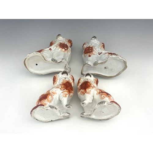 1029 - A Staffordshire figure group of spaniels, circa 1860, two matching pairs of seated Staffordshire spa... 