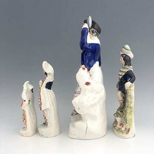 1030 - Four Staffordshire figure groups, circa 1850, including a shepherd figure holding a crook and pigski... 