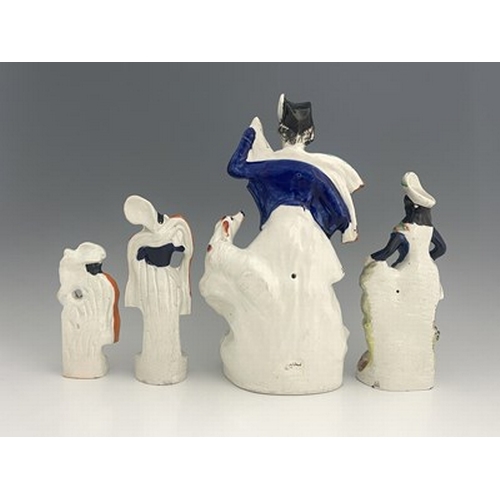 1030 - Four Staffordshire figure groups, circa 1850, including a shepherd figure holding a crook and pigski... 