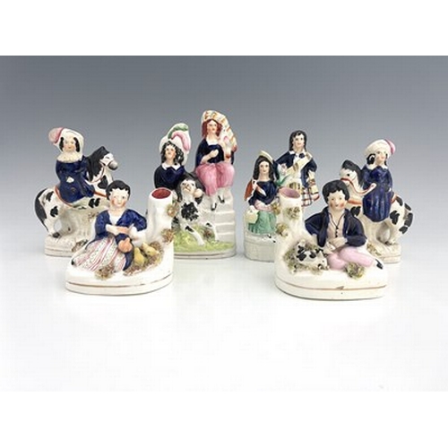 1032 - Six Staffordshire royal children figure groups, circa 1860, modelled as a seated girl in cobalt blue... 