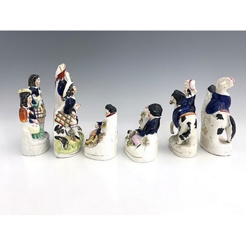 1032 - Six Staffordshire royal children figure groups, circa 1860, modelled as a seated girl in cobalt blue... 