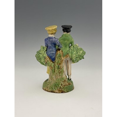 1033 - A Staffordshire pearlware figure group of the Dandies, with a dog, on green base, 18cm high