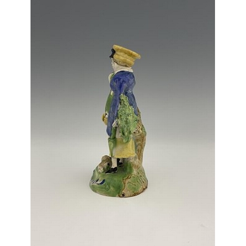 1033 - A Staffordshire pearlware figure group of the Dandies, with a dog, on green base, 18cm high