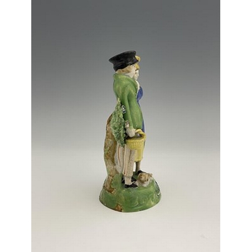 1033 - A Staffordshire pearlware figure group of the Dandies, with a dog, on green base, 18cm high