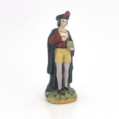 1034 - A Staffordshire figure of Hamlet, mid 19th Century, modelled standing holding the skull of Yorick, p... 